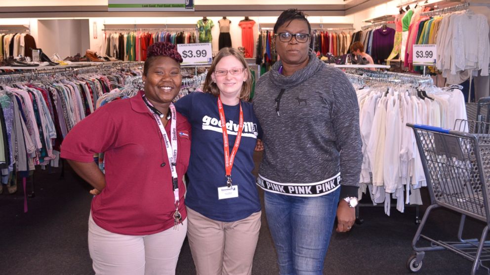Goodwill employee Kayla Holland, center, with her job coach and a Goodwill Assistant Manager, found $1,400 cash inside a donated bag.
