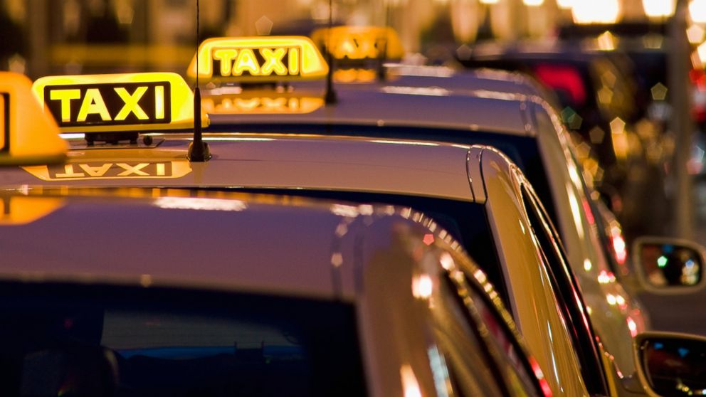 A line of taxi cabs are pictured in this stock image. 