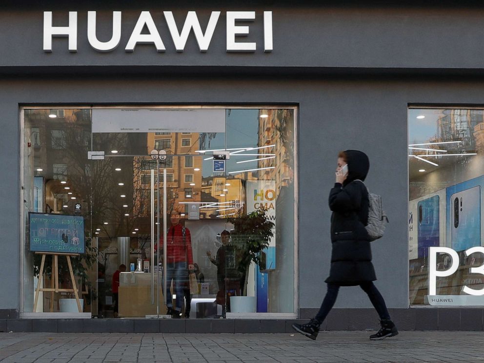 PHOTO: A woman speaks on her mobile phone as she walks past a Huawei store in, Kiev, Ukraine, Nov. 11, 2019.