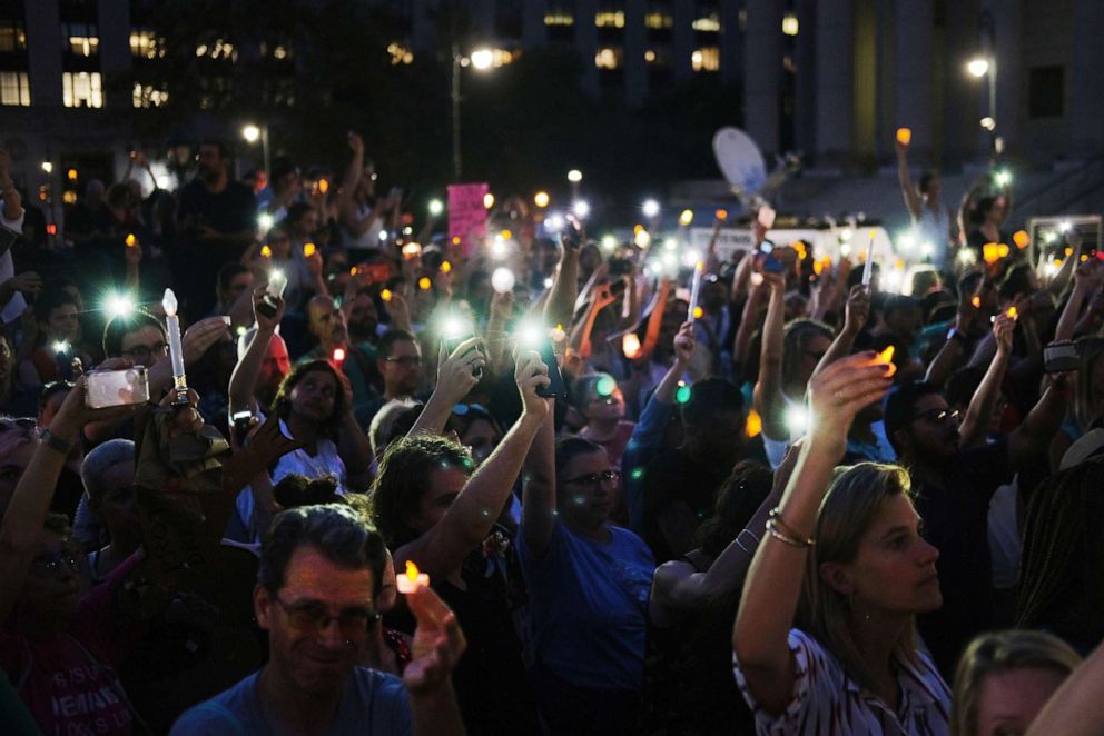PHOTO: Hundreds of people gather in lower Manhattan for a "Lights for Liberty" protest against migrant detention camps and the impending raids by Immigration and Customs Enforcement this coming weekend in various cities on July 12, 2019 in New York City.