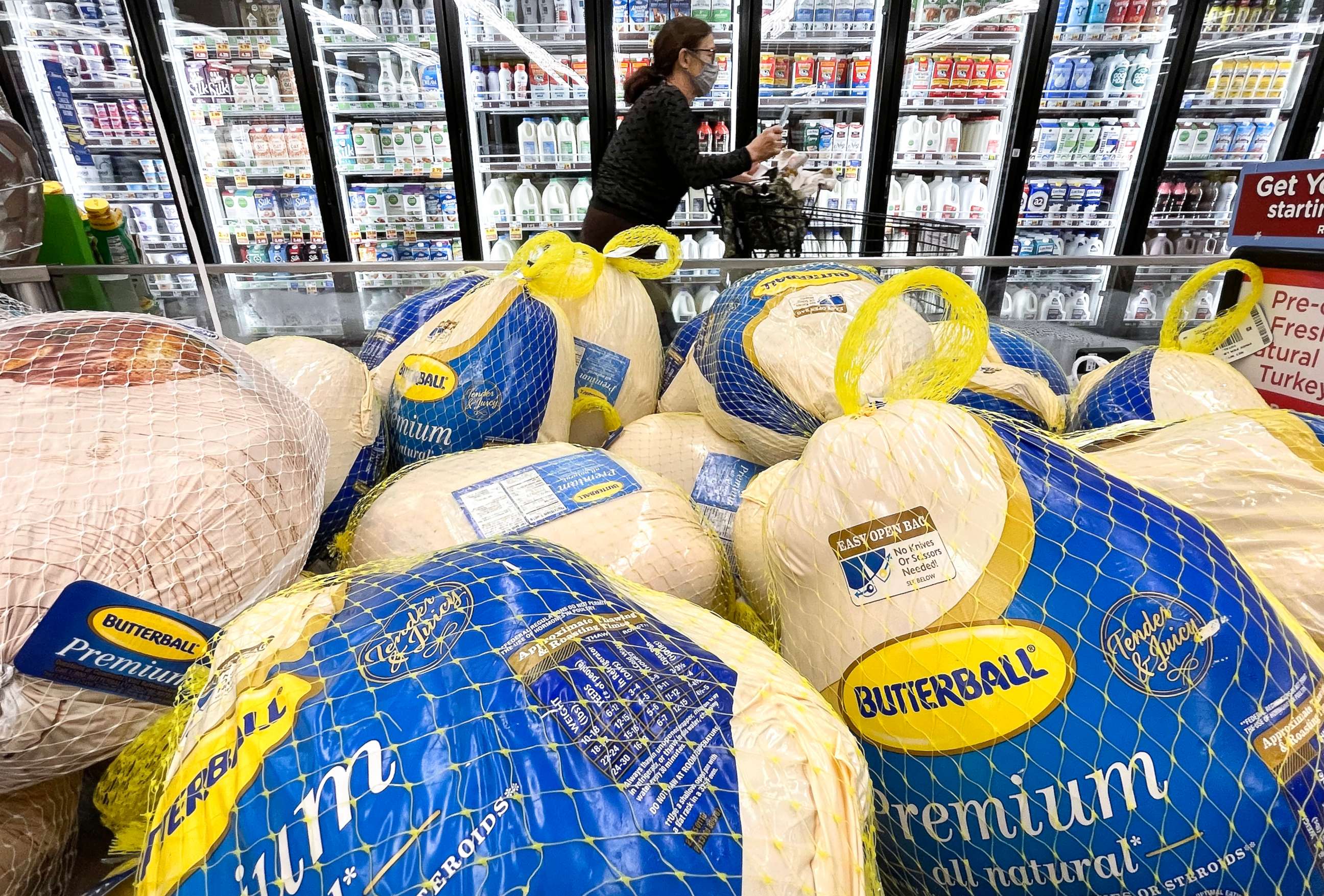 PHOTO: A shopper walks past turkeys displayed for sale in a grocery store ahead of the Thanksgiving holiday on Nov. 11, 2021, in Los Angeles.