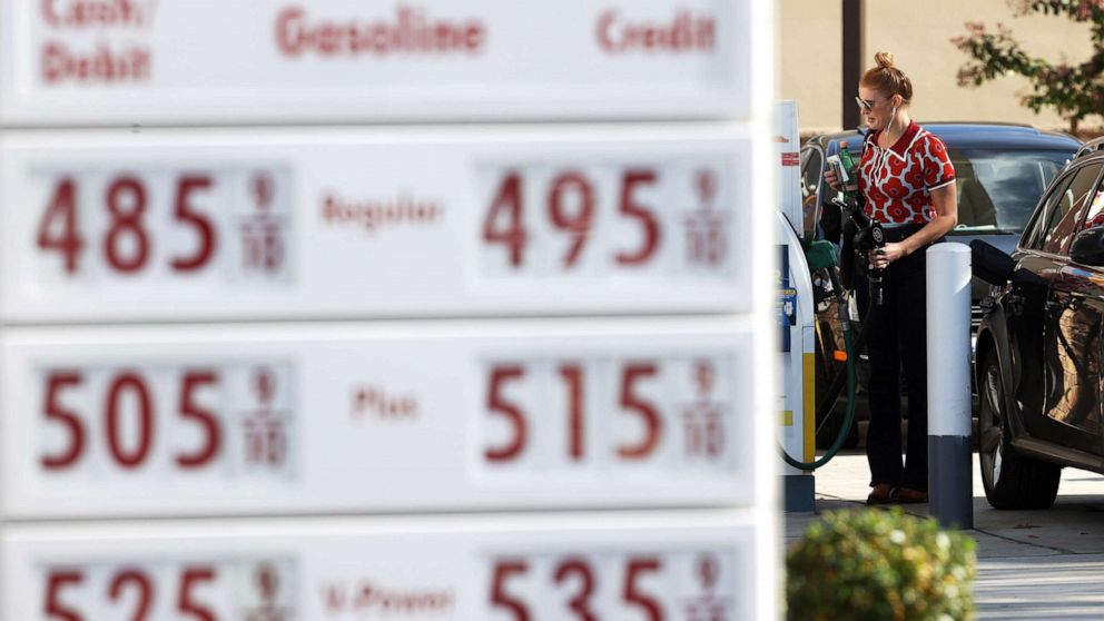 PHOTO: A customer prepares to pump gas into her car at a station in  San Rafael, Calif., Nov. 17, 2021. 