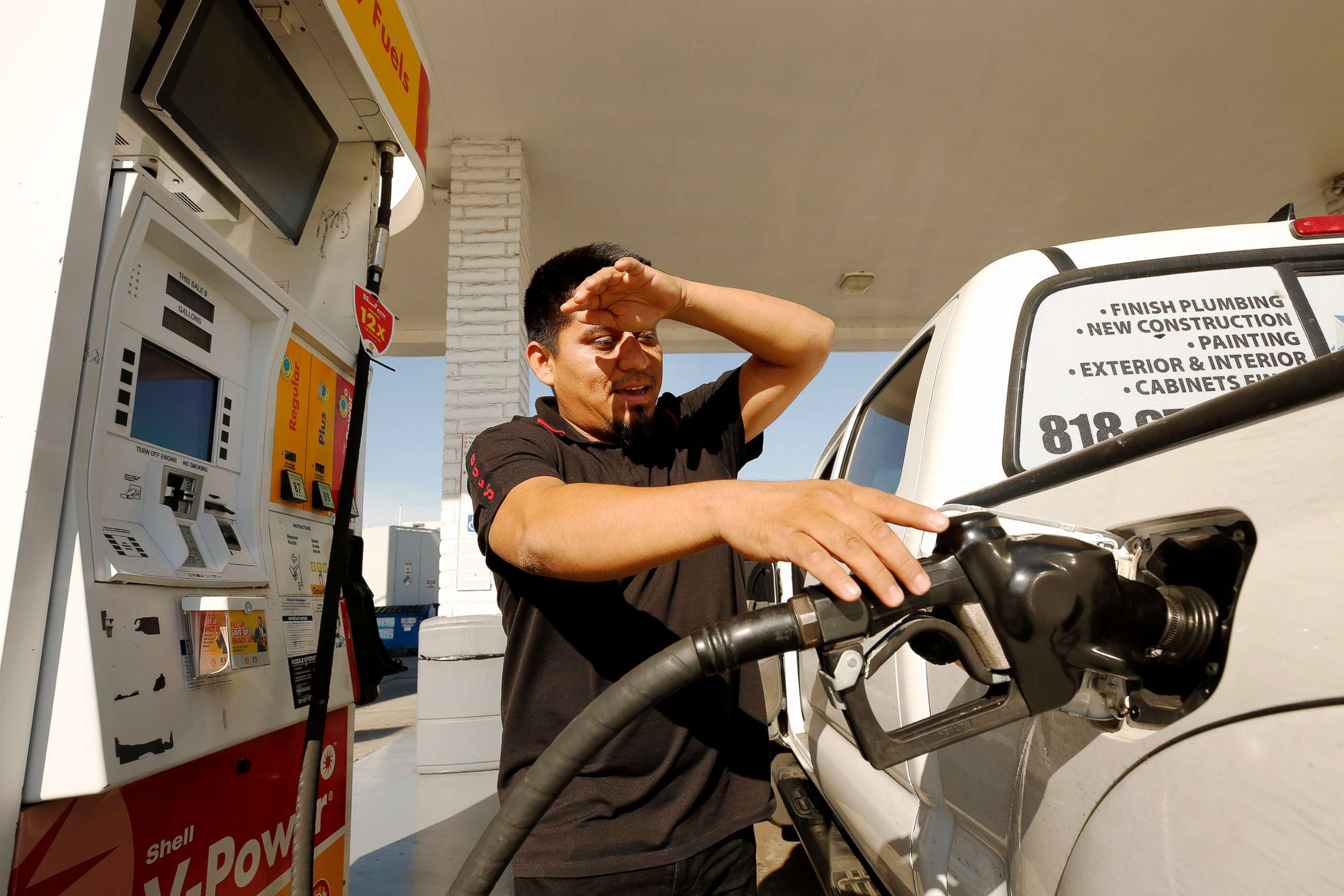 PHOTO: Alex Reyes, 28, began filling his work truck and stoped when he noticed the prices on the large marquee as drivers select from various fuels priced near of above over $6 dollars at a Shell gas station in Los Angeles, Nov. 15, 2021.