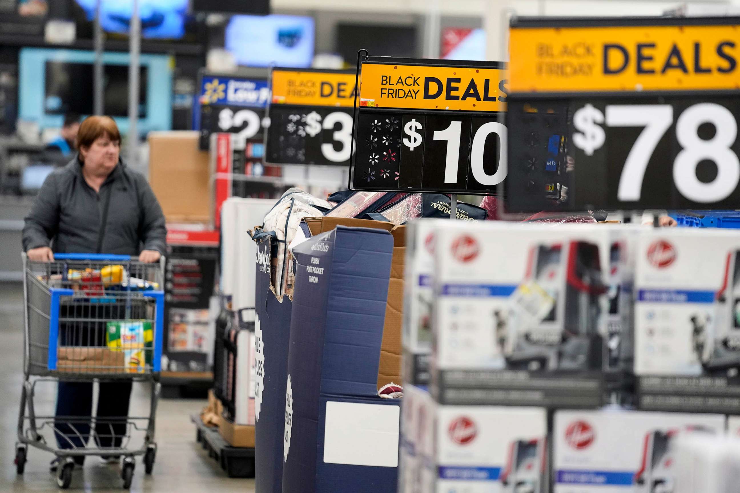 PHOTO: FILE - Signs advertise deals at a Walmart in Secaucus, N.J., Nov. 22, 2022.