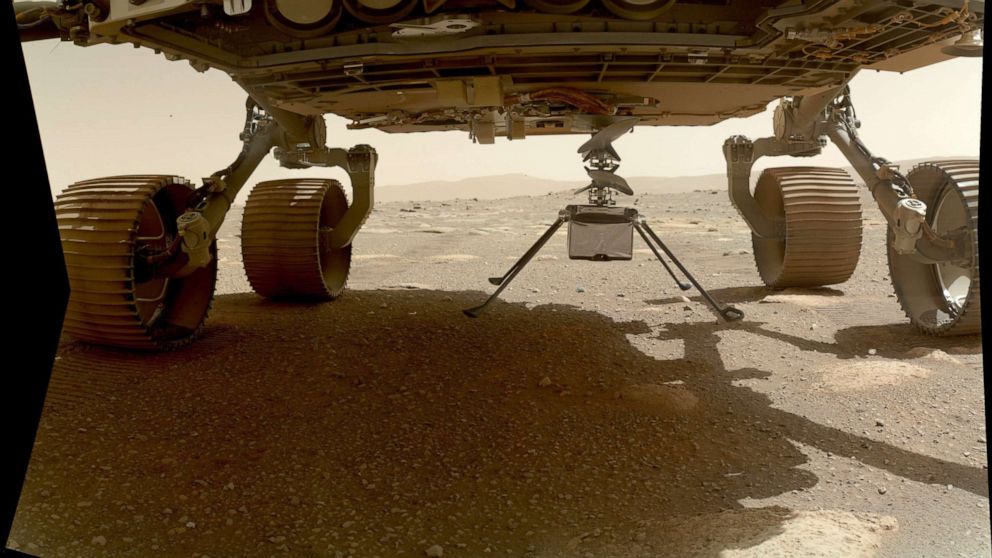 PHOTO: NASA's Ingenuity helicopter touches Mars after it was deployed from the belly of the Perseverance rover, March 30, 2021.