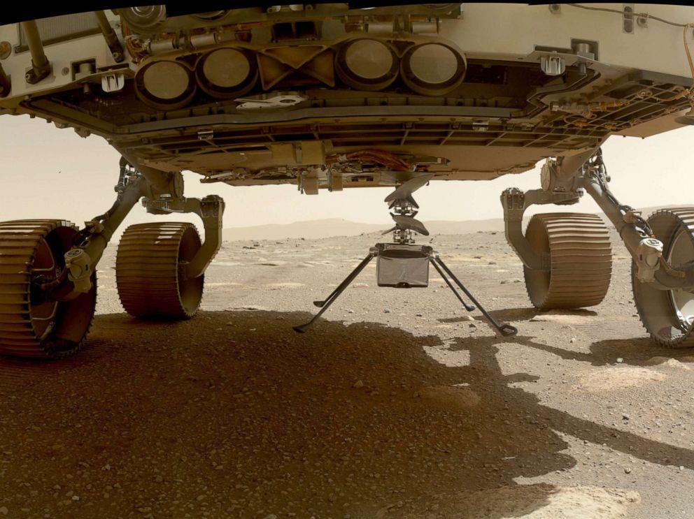 PHOTO: NASA's Ingenuity helicopter touches Mars after it was deployed from the belly of the Perseverance rover, March 30, 2021.