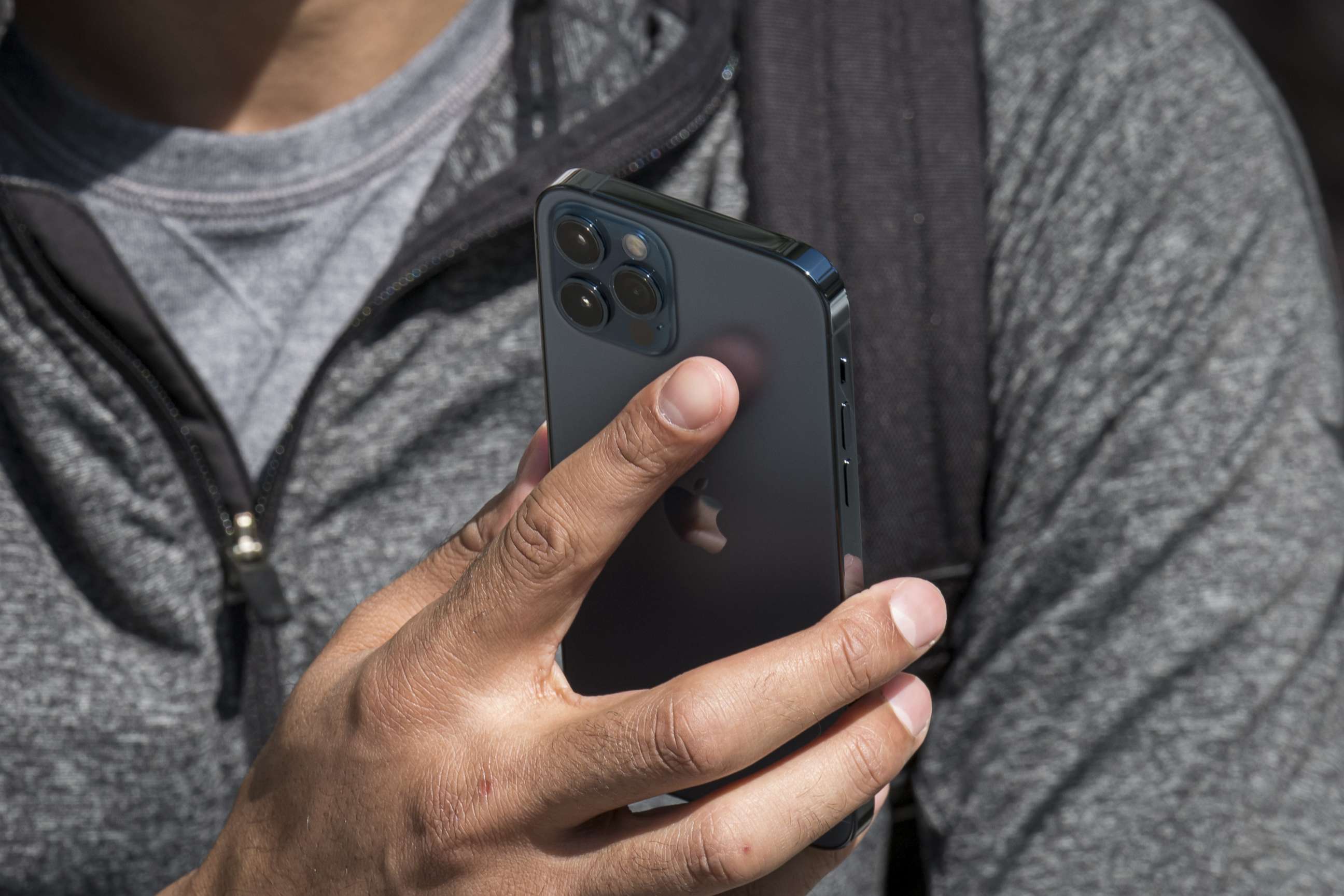 PHOTO: A customer holds a new Apple Inc. iPhone 12 Pro at an Apple Inc. store in San Francisco, Oct. 23, 2020.