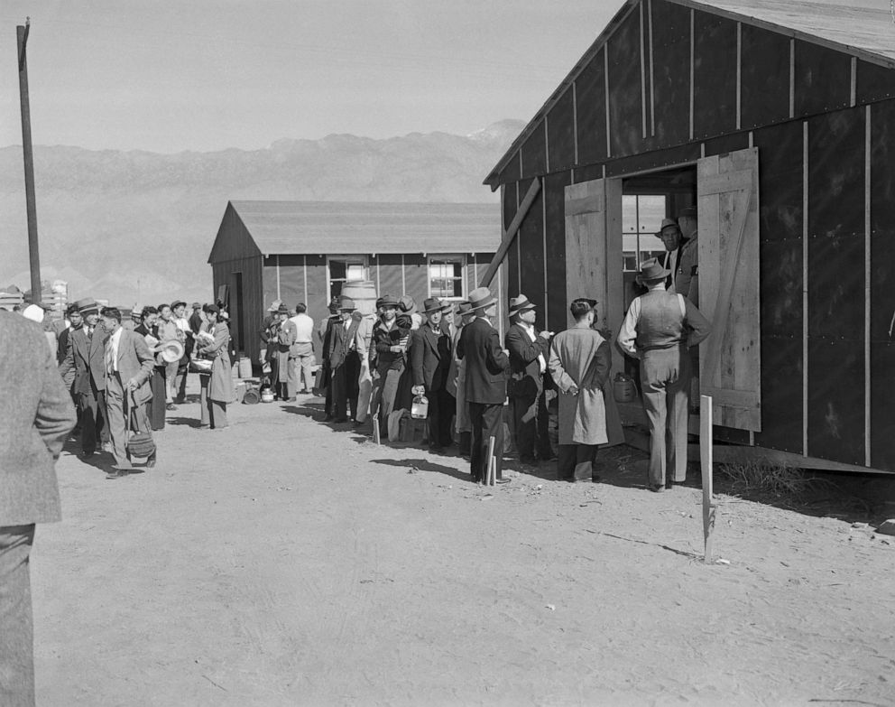 PHOTO: Japanese people lining up for registration at the Alien Reception Center, Manzanar, Calif., March 27, 1942.