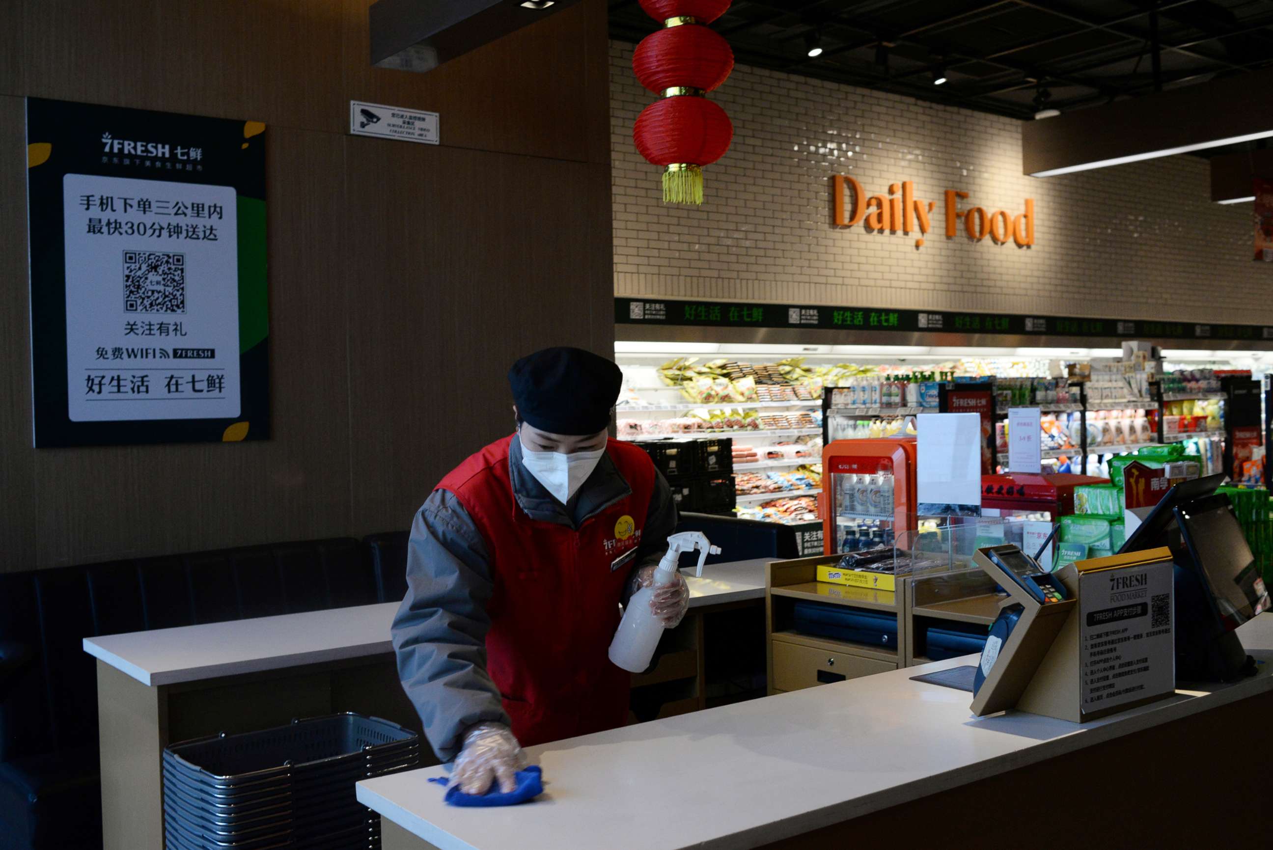 PHOTO: A staff member cleans a check counter at a JD.com's 7Fresh chain before the store opens, during an outbreak of the novel coronavirus, in Yizhuang town, Beijing, Feb. 8, 2020.