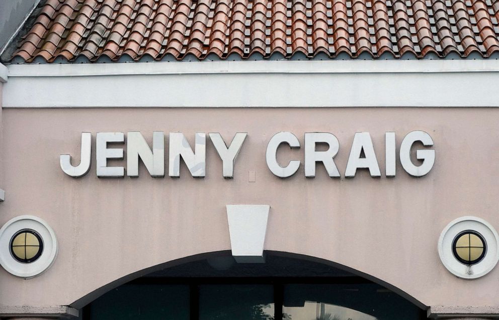 PHOTO: A Jenny Craig sign hangs on the wall outside of the weight loss store on April 28, 2023 in Miami.