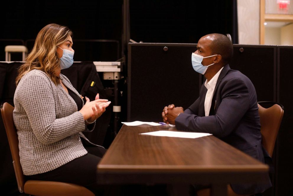 PHOTO: A Seminole Hard Rock Casino department manager (R) conducts an interview with a potential employee during a job fair at the Seminole Hard Rock Casino on May 25, 2021, in Tampa, Fla.