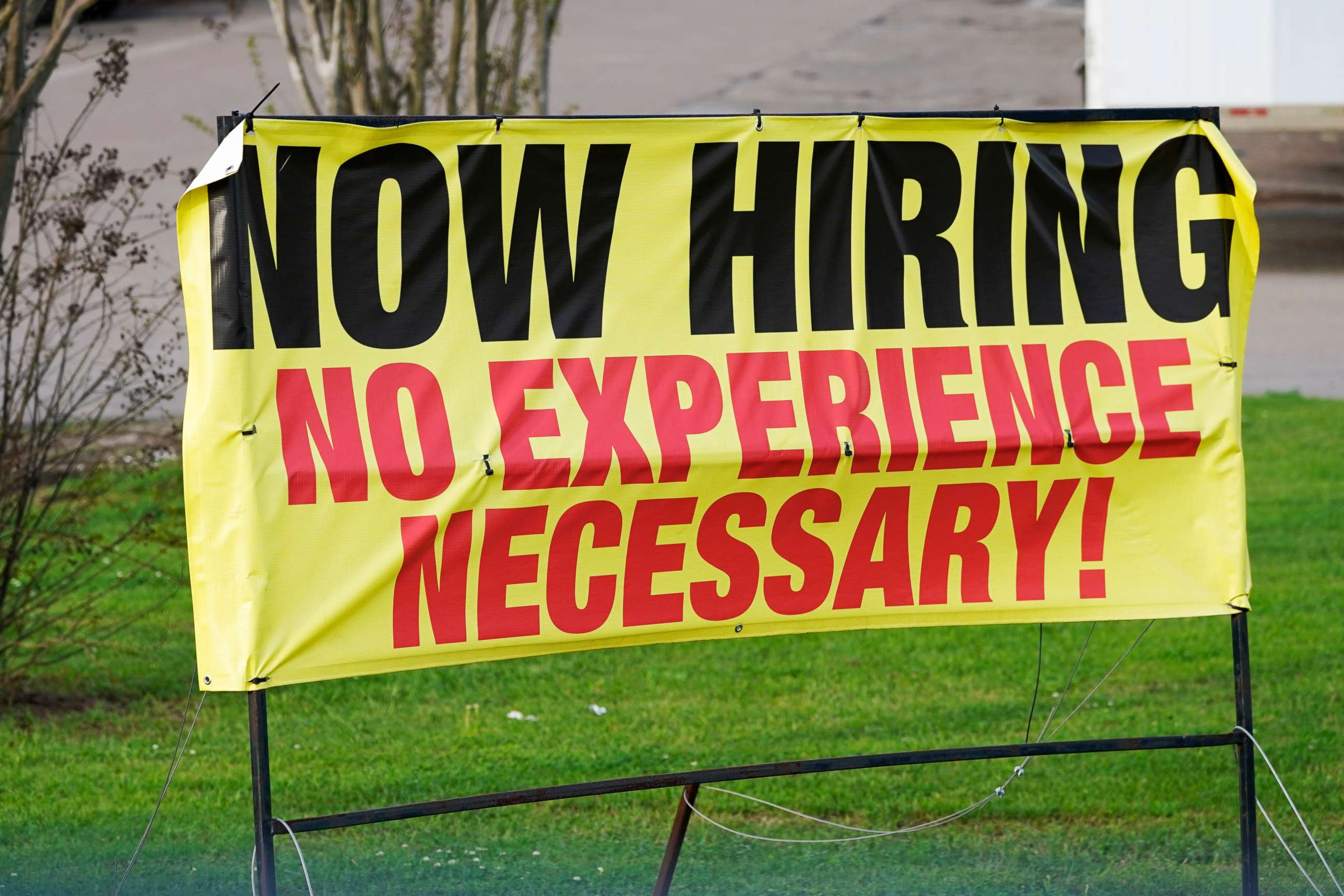 PHOTO: AA roadside banner beckons potential employees outside Channel Control Merchants LLC, an extreme value retailer and exporter of brand sensitive secondary market inventories, in Hattiesburg, Miss., March 27, 2021.