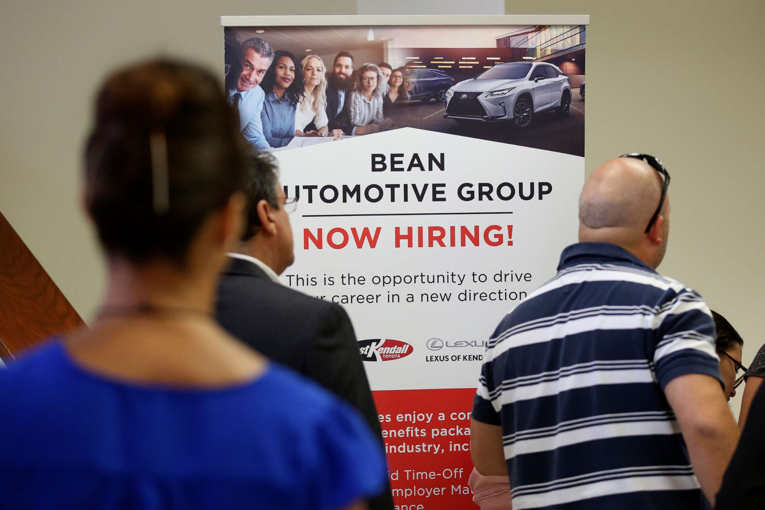 PHOTO: People stand in line to inquire about jobs available during a job fair, Sept. 18, 2019, in Miami.