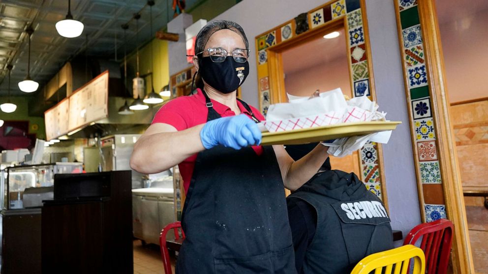 PHOTO: A waitress works at a restaurant in Chicago, March 23, 2023.