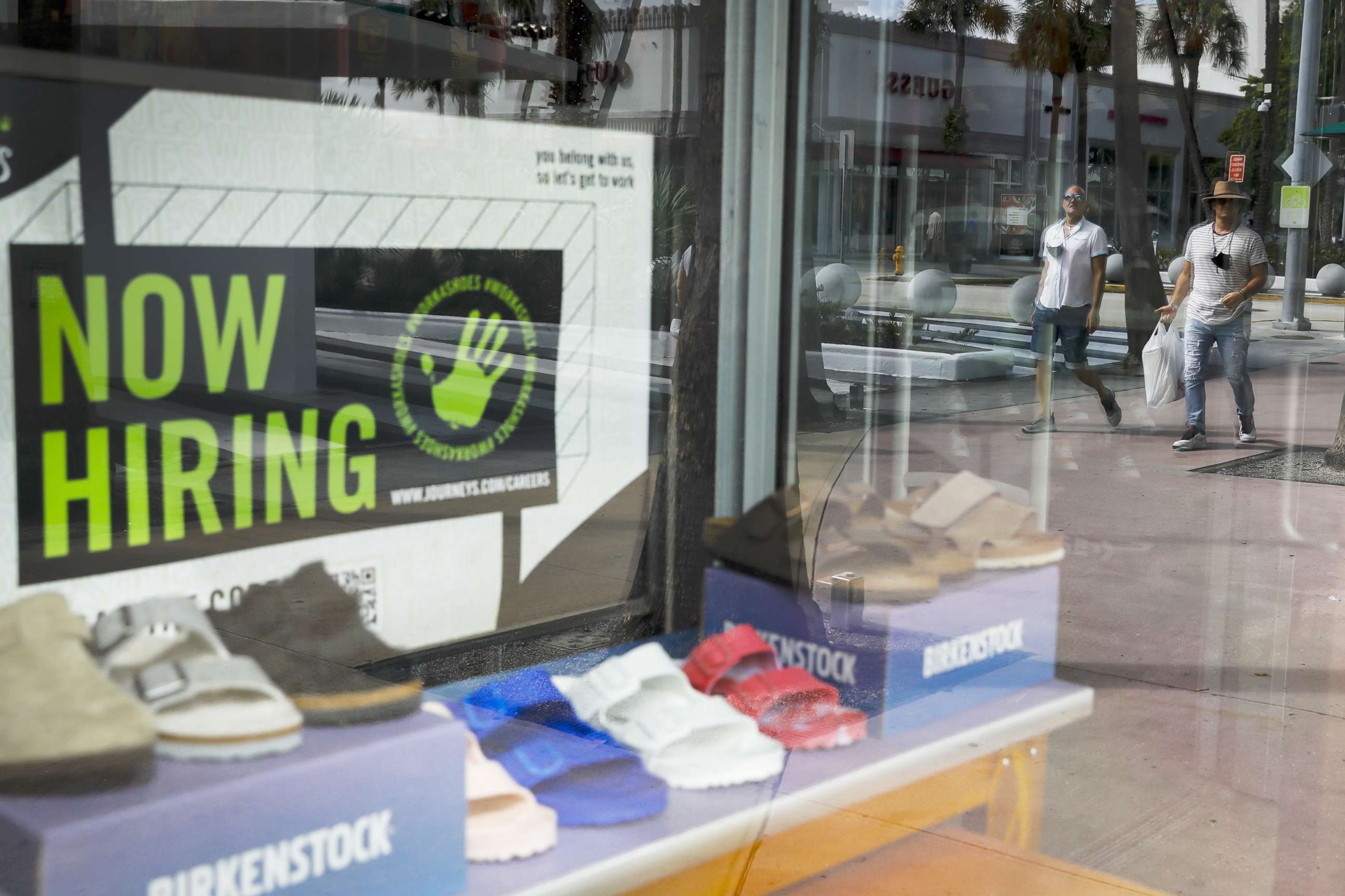 PHOTO: A sign advertising "Now Hiring" outside a shoe store in Miami, Oct. 23, 2021.