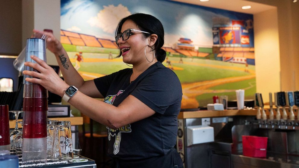 PHOTO: Karen Rosa, a bartender who was newly hired this year, works the bar at the Lost Dog Cafe, in Fairfax, Va., Aug. 27, 2021.
