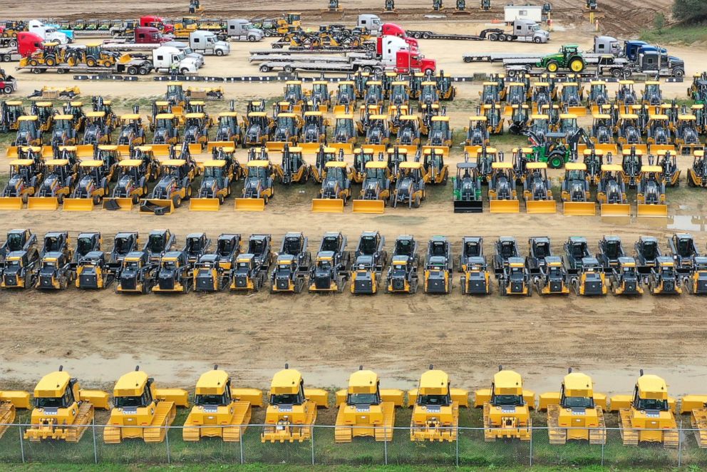 PHOTO: In this aerial view, construction and farming vehicles manufactured by John Deere are loaded onto trucks at the John Deere Dubuque Works facility on Oct. 15, 2021, in Dubuque, Iowa.