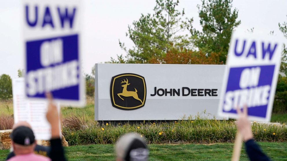 PHOTO: Members of the United Auto Workers strike outside of a John Deere plant on Oct. 20, 2021, in Ankeny, Iowa.