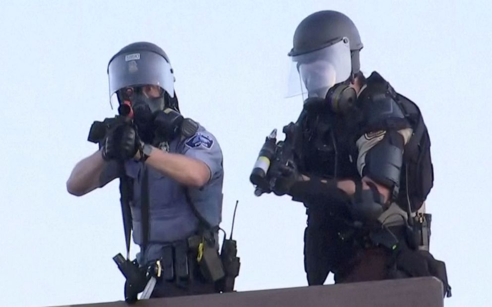 PHOTO: Police aim at a Reuters TV cameraman during a protest in Minneapolis, May 30, 2020.