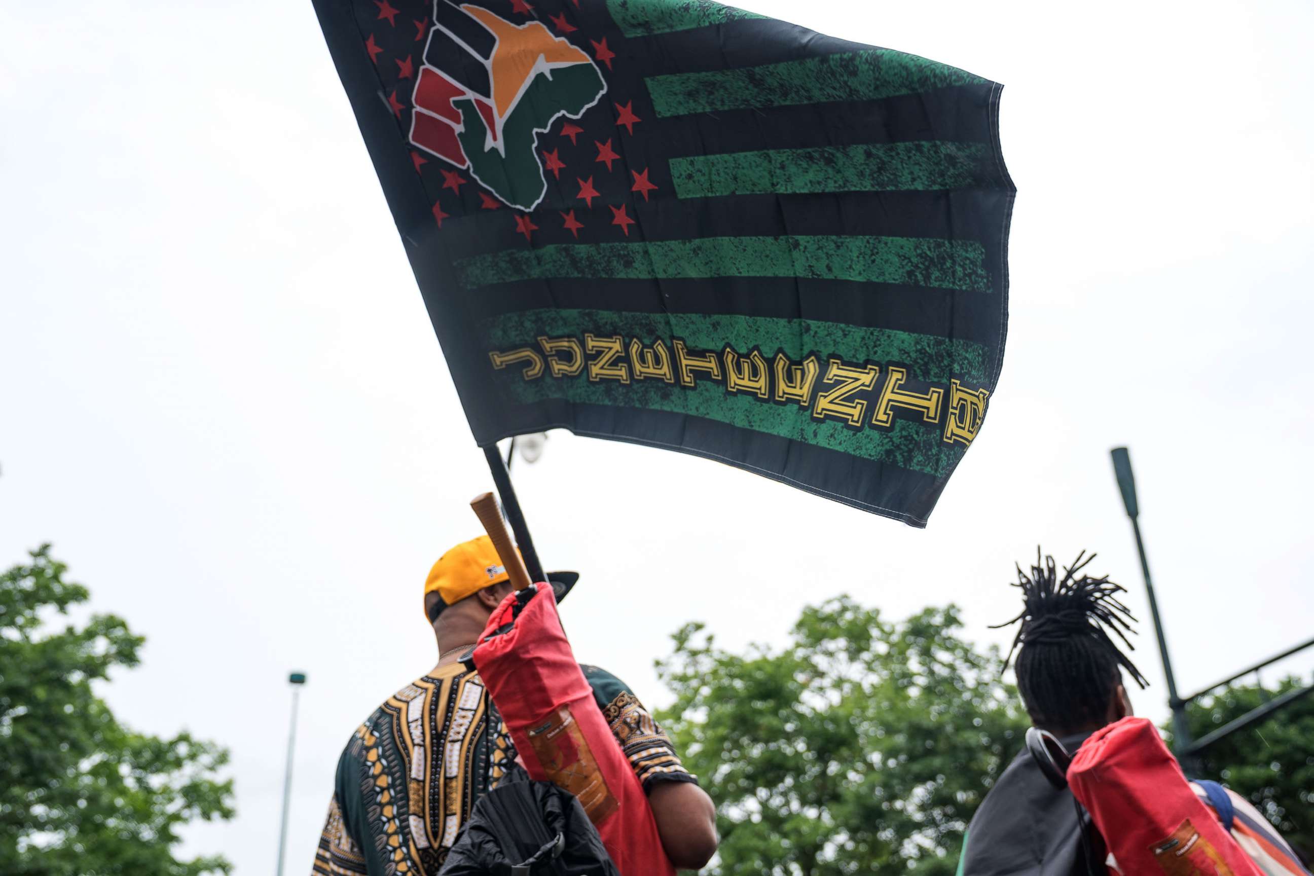 PHOTO: People watch a parade taking place to celebrate Juneteenth, June 19, 2021, in Atlanta.