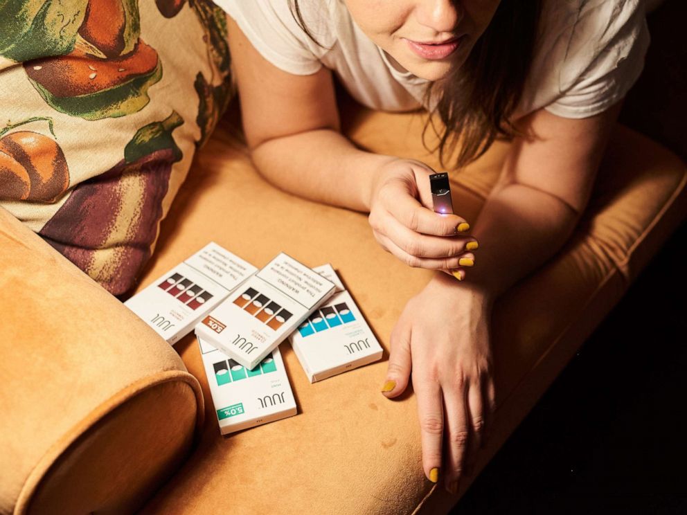 PHOTO: A person smokes a Juul Labs Inc. e-cigarette in this arranged photograph taken in the Brooklyn Borough of New York, U.S., on Thursday, Dec. 20, 2018.