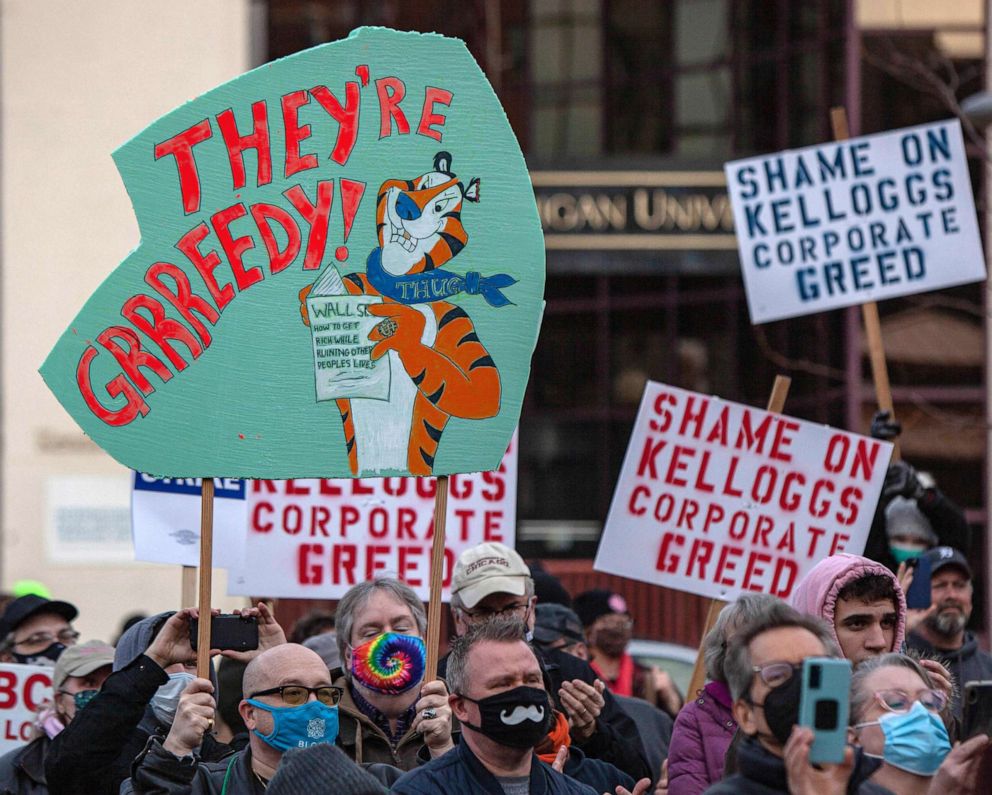 PHOTO: People hold signs during a rally where Senator Bernie Sanders spoke to striking Kellogg workers in downtown Battle Creek, Mich., Dec. 17, 2021.