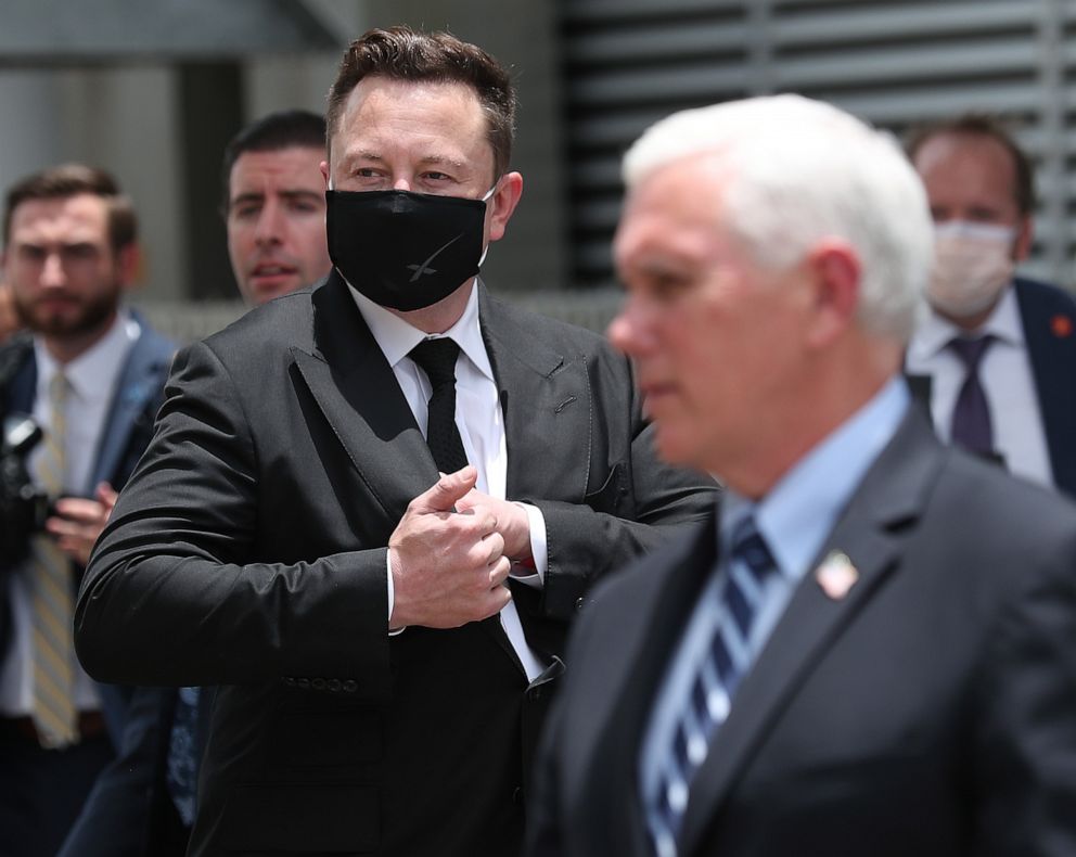 PHOTO: SpaceX founder Elon Musk (L) wears a face mask while standing next to U.S. Vice President Mike Pence at the Kennedy Space Center on May 27, 2020.