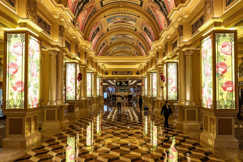 PHOTO: In this Feb. 5, 2020, file photo, staff walk in the hallway of The Venetian Macau after the closing of its casino in Macau, China.