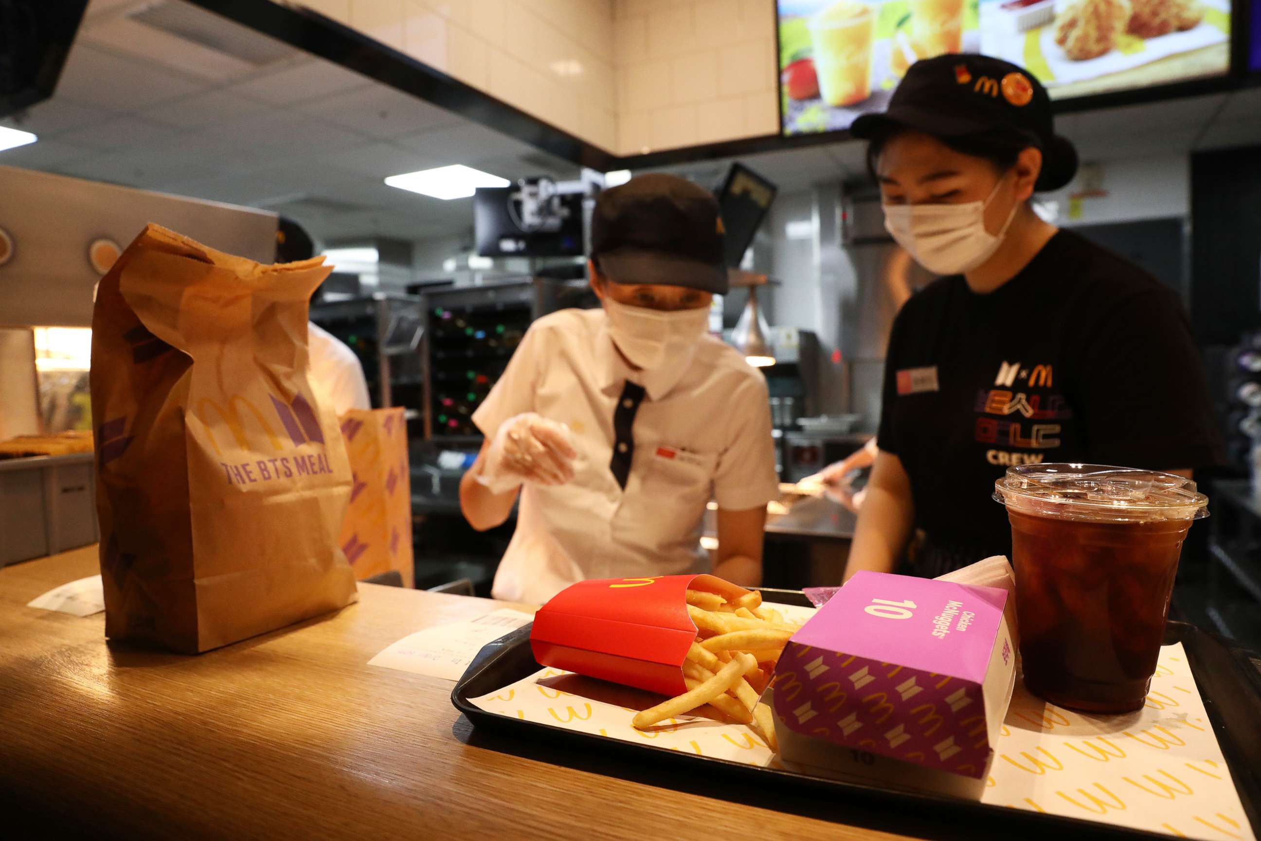 PHOTO: Employees of McDonald's serve a BTS meal on May 27, 2021 in Seoul, South Korea.