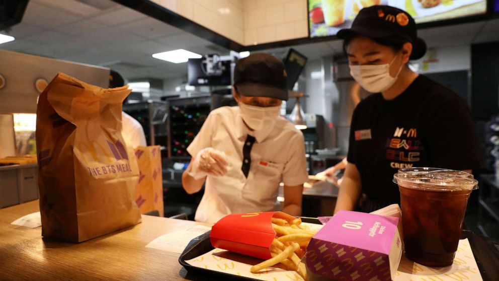 PHOTO: Employees of McDonald's serve a BTS meal on May 27, 2021 in Seoul, South Korea.
