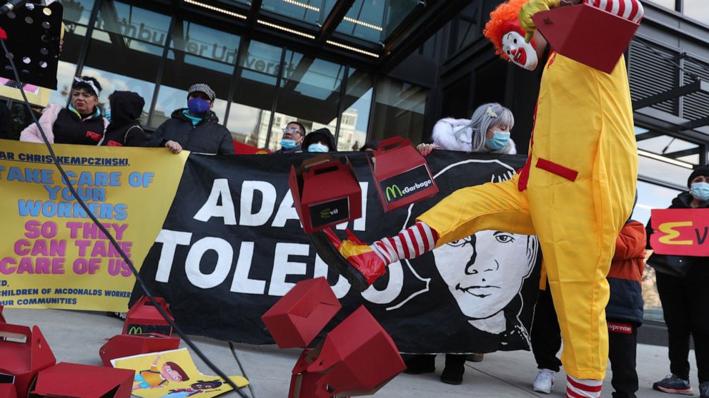 PHOTO: Dressed as Ronald McDonald, Kristian Armendariz kicks empty food boxes that resemble McDonald's Happy Meals during a protest outside the company's corporate office, Nov. 3, 2021, in Chicago. 