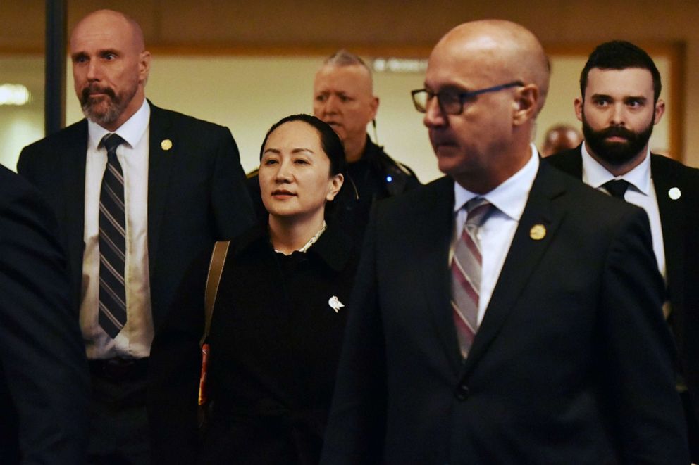 PHOTO: Huawei chief financial officer Meng Wanzhou, after a short morning session that ended the fourth day of trial in her extradition case, leaves British Columbia Supreme Court with her security detail in Vancouver, Jan. 23, 2020.