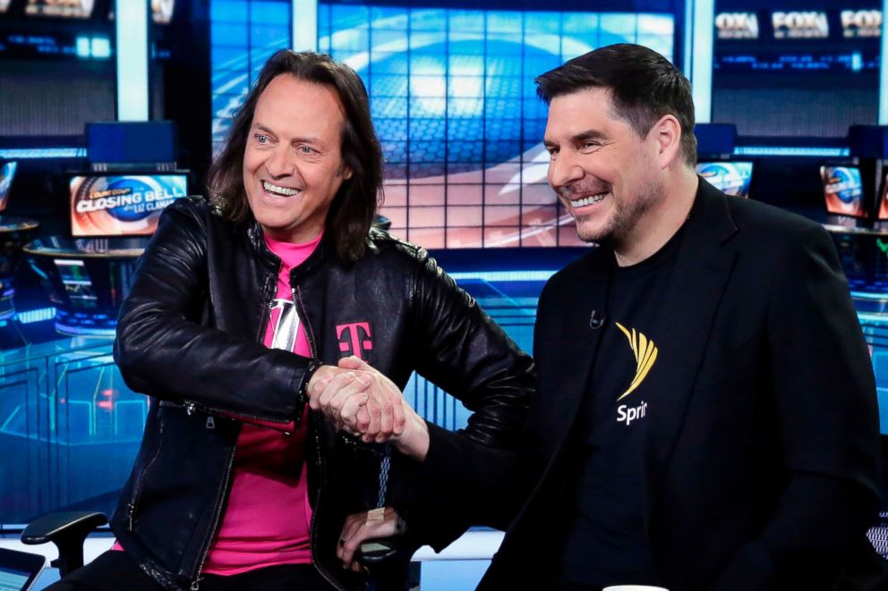 PHOTO: T-Mobile CEO John Legere and Sprint CEO Marcelo Claure shake hands as they are interviewed by Liz Claman during her "Countdown to the Closing Bell" program on the Fox Business Network, in New York, April 30, 2018. 