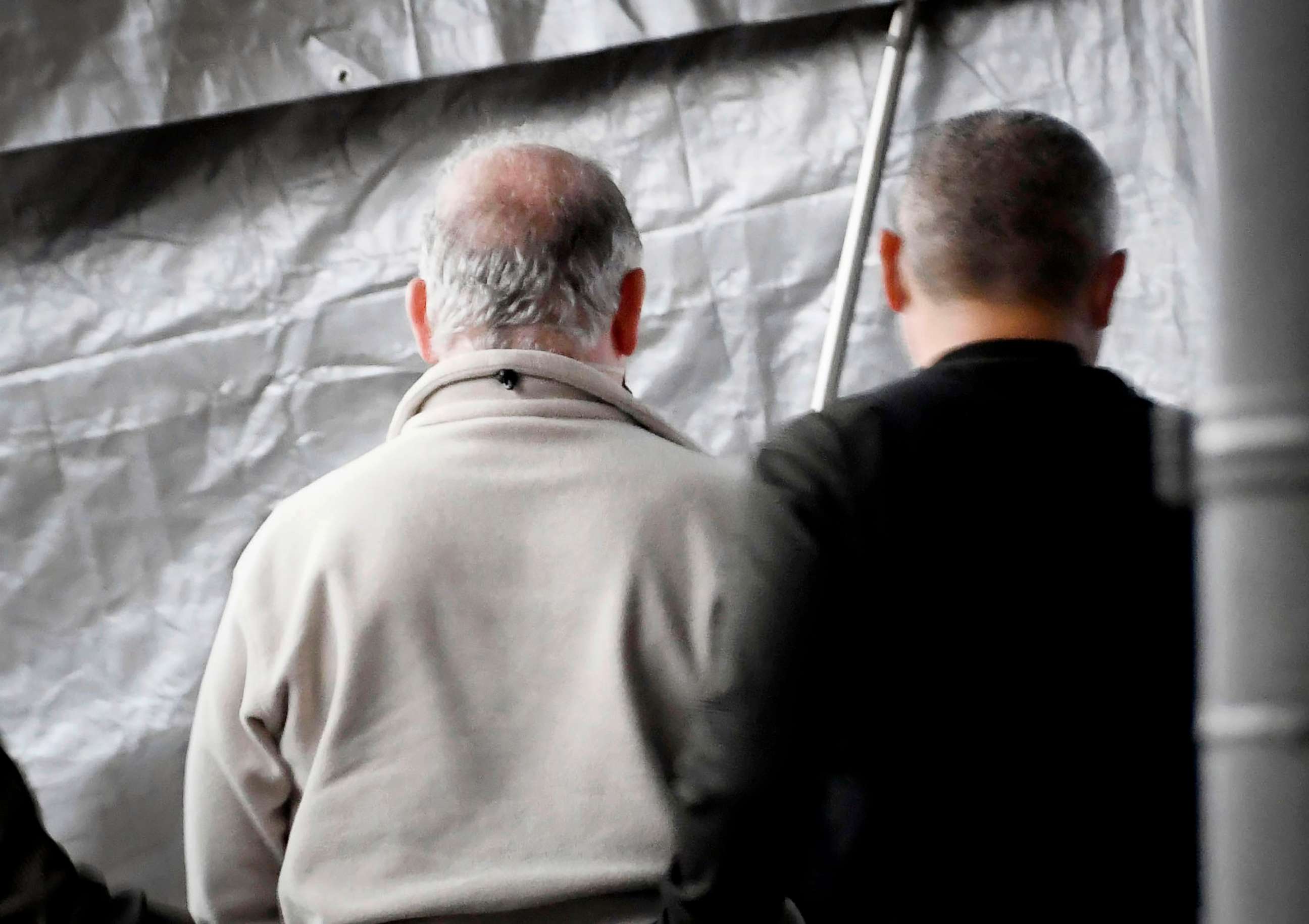 PHOTO: A man, left, who appears to be Michael Taylor, arrives at Narita Airport in Narita, east of Tokyo, March 2, 2021. Two Americans suspected of helping former Nissan Chairman Carlos Ghosn skip bail and escape to Lebanon have been extradited to Japan.