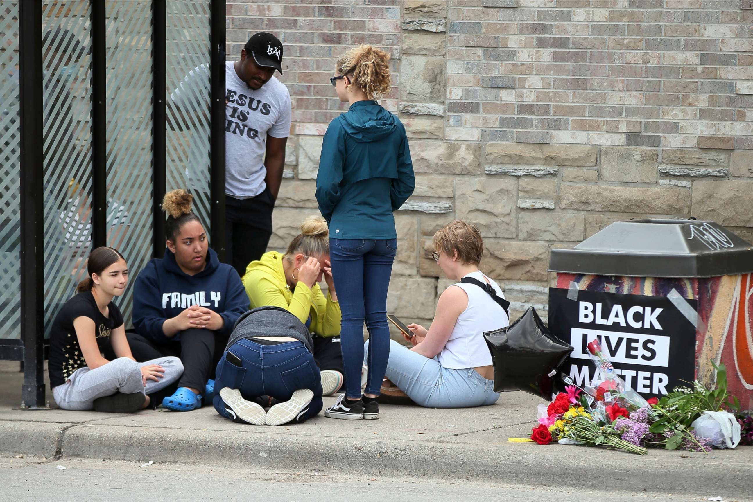 PHOTO: Mourners gather around a makeshift memorial, Tuesday, May 26, 2020 in Minneapolis, near where an black man was taken into police custody the day before who later died.
