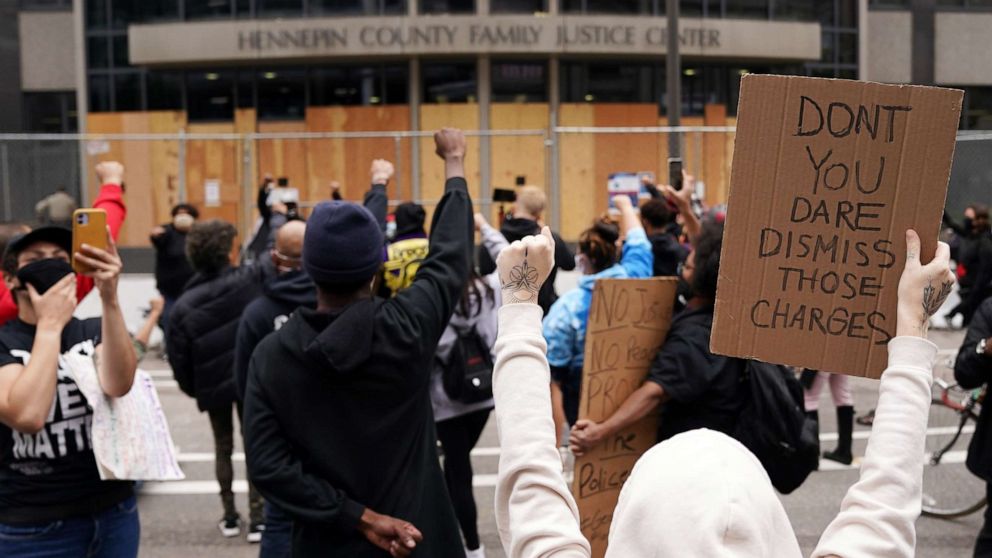 PHOTO: Protesters chant outside the Hennepin County Family Justice Center following a hearing in the cases against four former officers in the killing of George Floyd, in Minneapolis, Sept. 11, 2020.