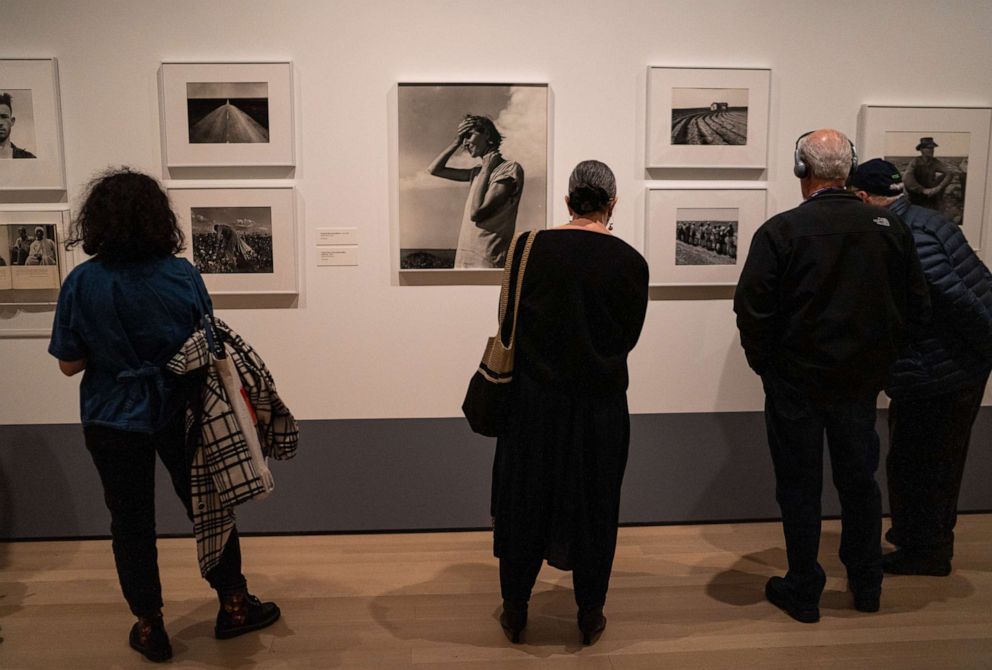 PHOTO: Viewers take in the images of documentary photographer Dorothea Lange (1895-1965) at an exhibition in the Museum of Modern Art in New York, March 7, 2020. 