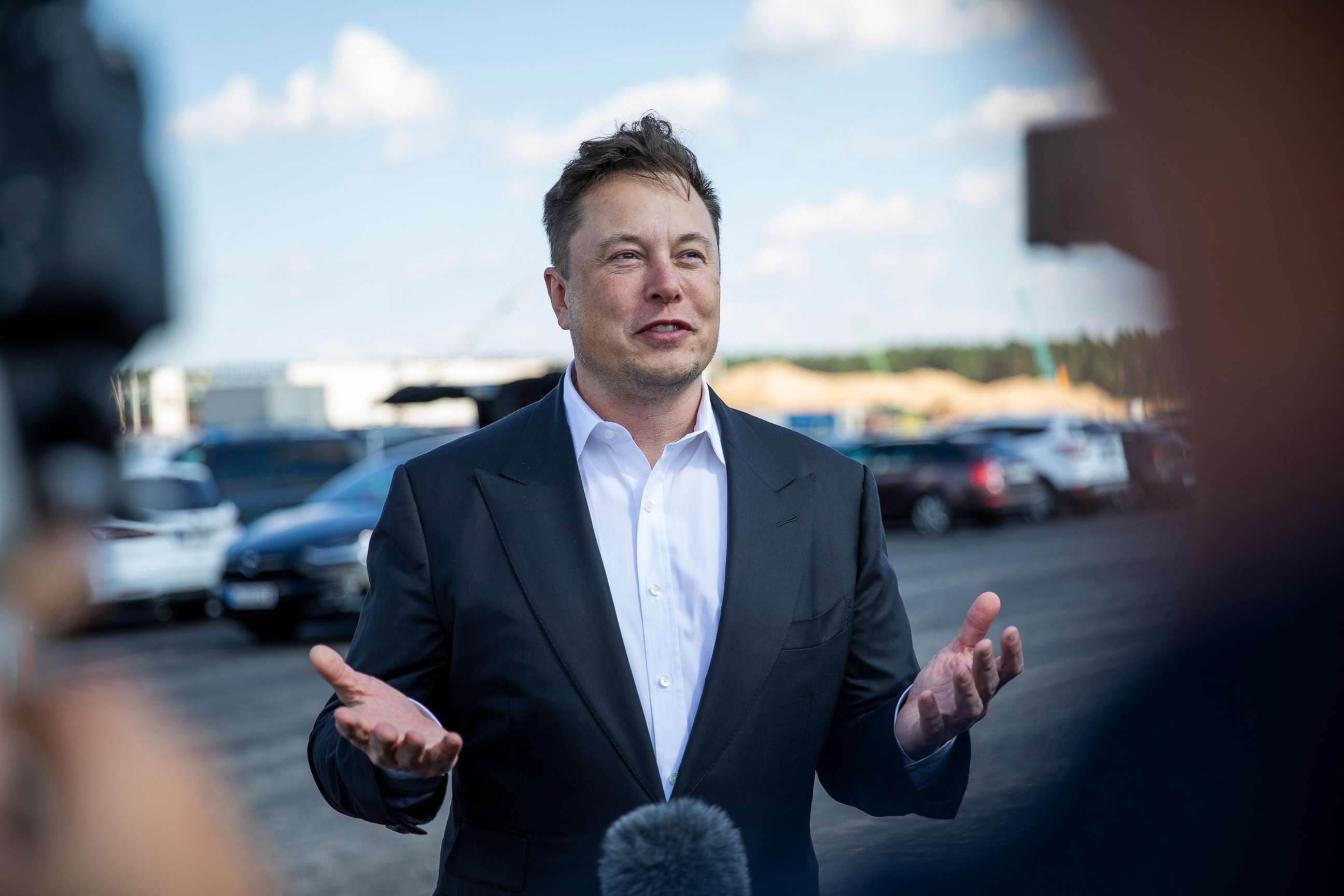PHOTO: Tesla head Elon Musk talks to the press as he arrives at the construction site of the new Tesla Gigafactory near Berlin on Sept. 03, 2020 near Gruenheide, Germany.