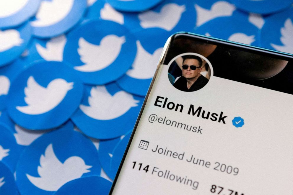 PHOTO: Elon Musk's Twitter profile is seen on a smartphone placed on printed Twitter logos in this picture illustration taken April 28, 2022.
