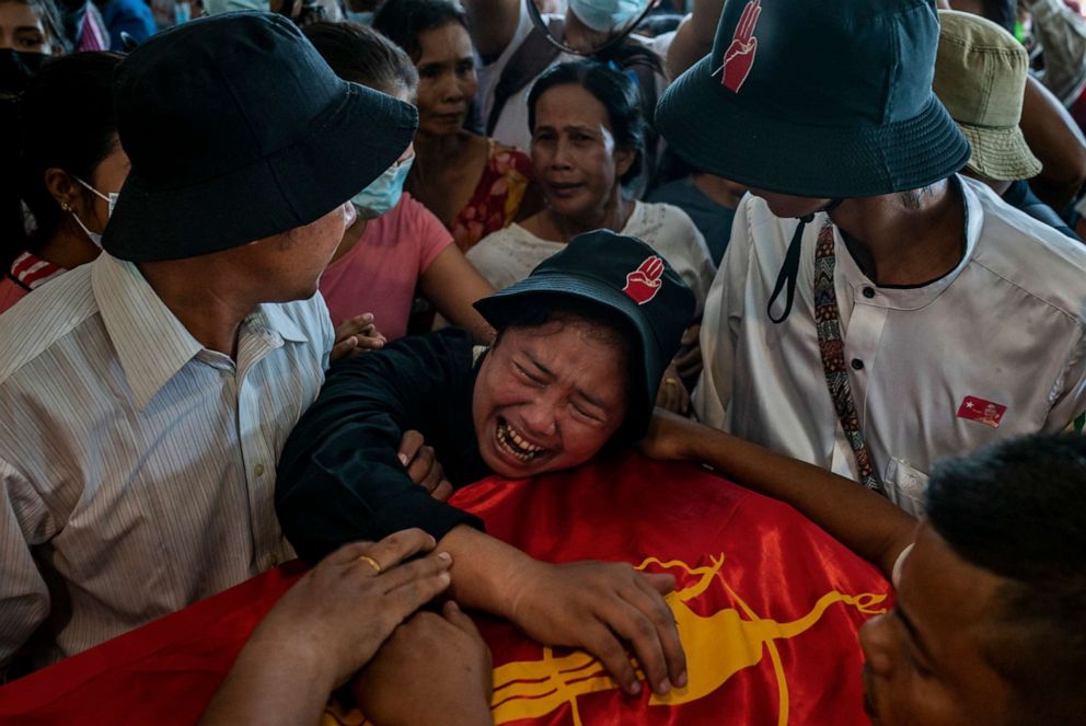 PHOTO: A sister of Zwal Htet Soe, 26, mourns over the coffin containing his body during a funeral for protesters who were shot dead in clashes with military and police on March 05, 2021, at the Yay Way cemetery in Yangon, Myanmar.