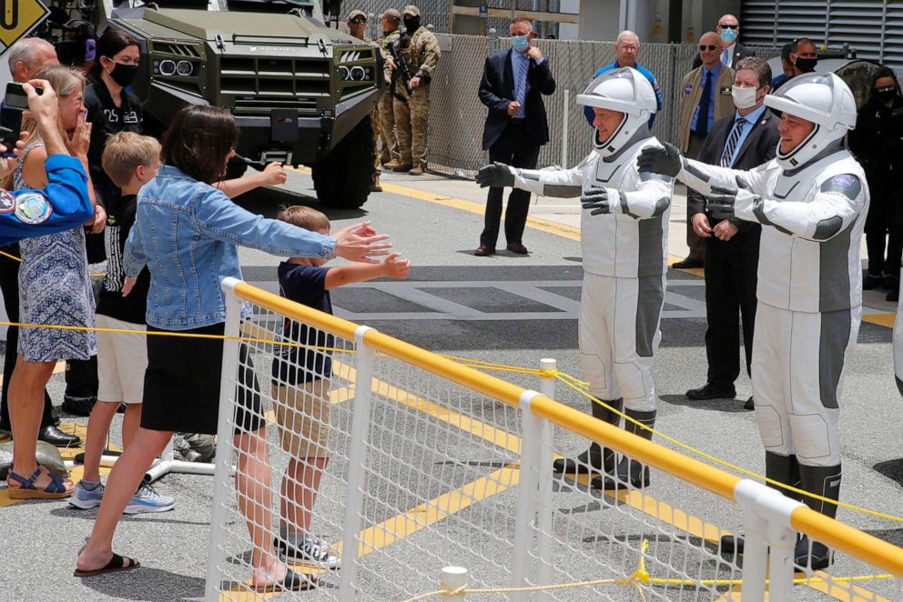 PHOTO: NASA astronauts Doug Hurley and Bob Behnken greet their families before the launch of a SpaceX Falcon 9 rocket and Crew Dragon spacecraft at the Kennedy Space Center, in Cape Canaveral, Fla., May 27, 2020.