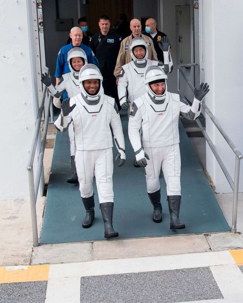 PHOTO: NASA astronauts Victor Glover, front L, Mike Hopkins, front R, Shannon Walker, back L, and Japan Aerospace Exploration Agency (JAXA) astronaut Soichi Noguchi, back R, wave, Nov. 12, 2020, at NASAs Kennedy Space Center in Florida.