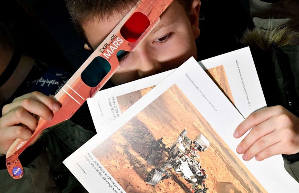 PHOTO: A Bosnian youth holds 3D glasses and leaflets as his school marks the landing of NASAs Perseverance Mars rover on the planet Mars, at an elementary school in the village of Jezero, Bosnia, Feb. 18, 2021.