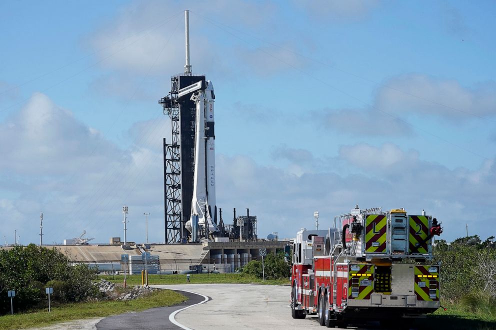 PHOTO: NASA firefighters drive on the road outside the fence near a SpaceX Falcon 9 rocket sits on the launch pad at at the Kennedy Space Center in Cape Canaveral, Fla., Nov. 13. 2020.