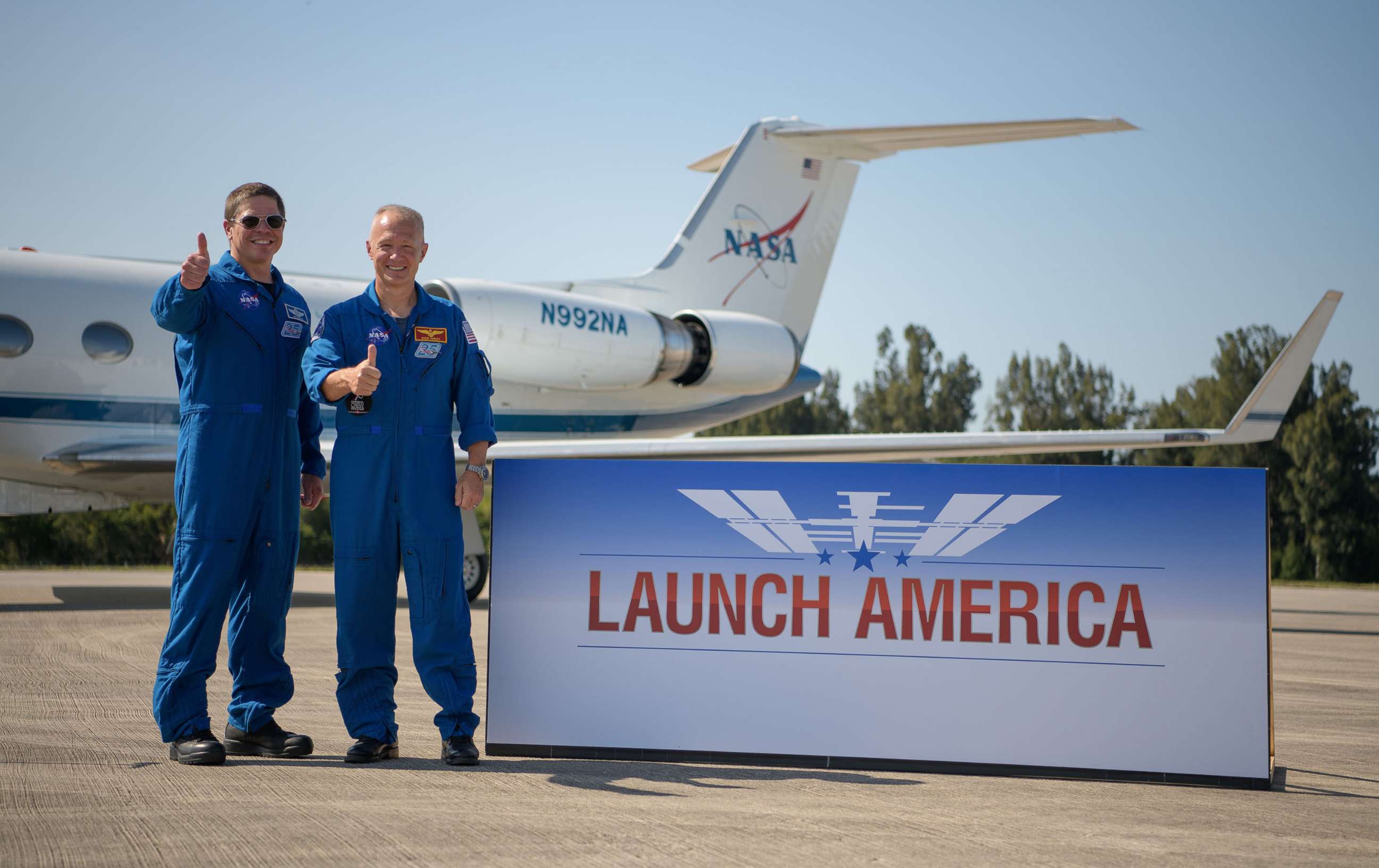 PHOTO: NASA astronauts Robert Behnken, left, and Douglas Hurley gives a thumbs up after arriving at the Launch and Landing Facility at NASA's Kennedy Space Center ahead of SpaceX's Demo-2 mission, May 20, 2020, in Florida.