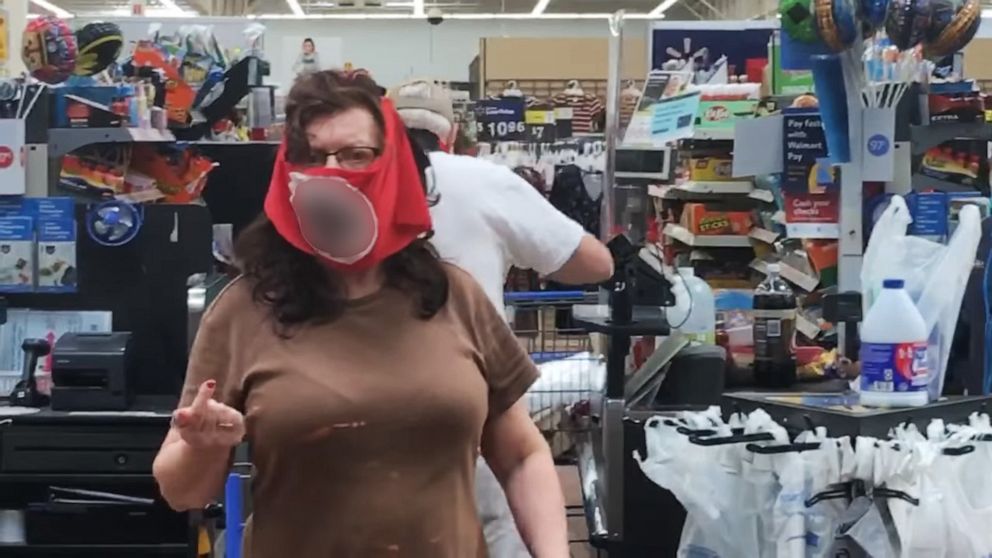 PHOTO: A couple wears face coverings with swastikas in an image made from a now-viral video filmed at a Walmart in Marshall, Minn., on July 25, 2020.