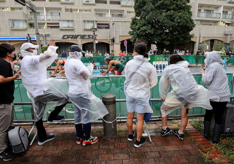 PHOTO: Fans watch the women's triathlon event near Odaiba Marine Park, surrounded by heavy wind caused by tropical storm Nepartak in Tokyo, July 27, 2021.