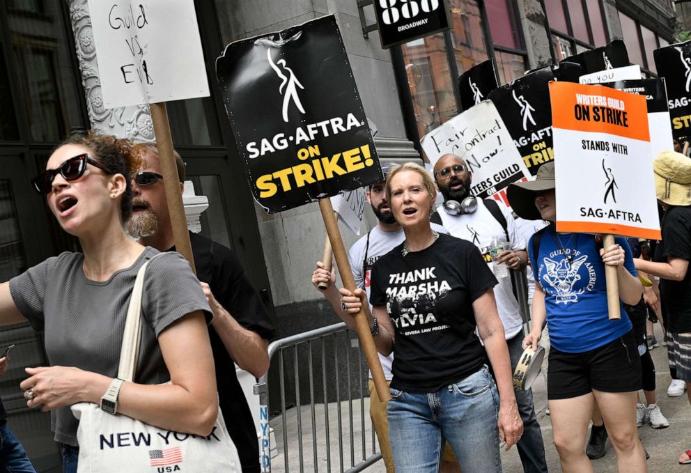 PHOTO: Cynthia Nixon, center, carries a sign on the picket line outside Netflix, July 21, 2023, in New York.