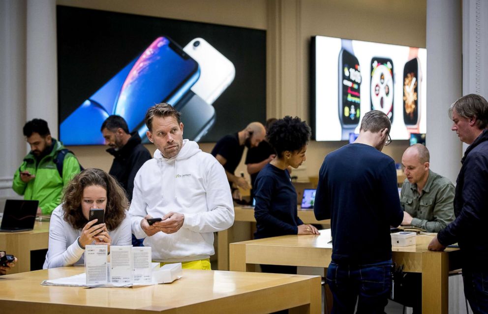 PHOTO: Bas van der Putten, second from left, was the first customer in line who bought a new iPhone at the Apple Store in Amsterdam, Sept. 21, 2018. 