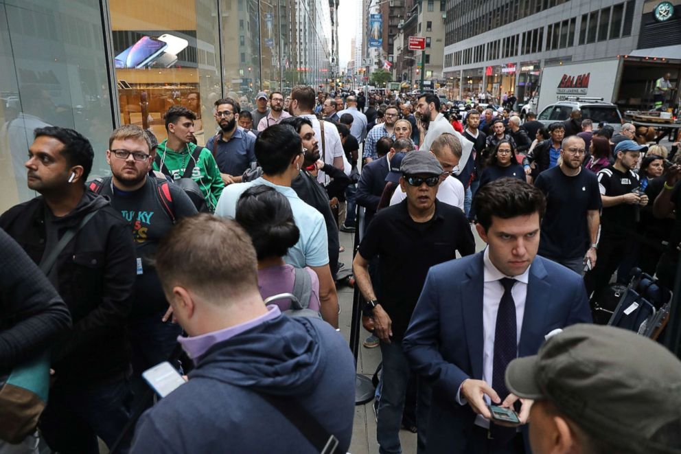 PHOTO: People wait in line to purchase the new iPhone XS and XS Max at the Apple store in Midtown Manhattan on Sept. 21, 2018, in New York City. 